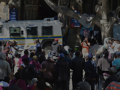 Refugee demonstrators occupy the vicinity outside the Old Townhouse opposite the Central Methodist Church, joining counterparts in both indoor and outdoor protests, South Africa
