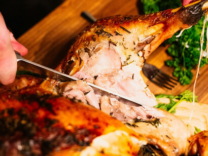 A traditional Christmas family dinner featuring a perfectly roasted chicken, celebrating togetherness and festive joy