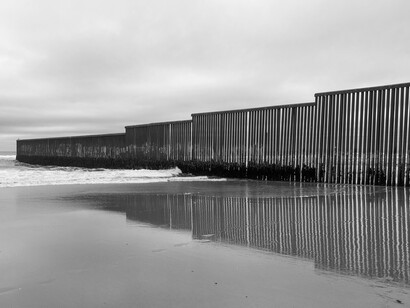 Border wall extending out to the sea at Tijuana, Mexico