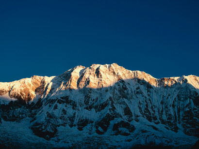 The Himalayas bathed in the light of the setting sun; the formation of these mountains began approximately 50 million years ago when the Australian tectonic plates collided with the Eurasian plate