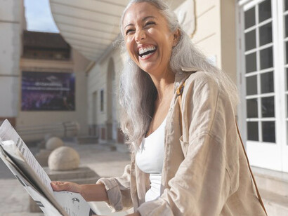 The post-truth era with an image of a woman engrossed in a newspaper titled 'fake news,' illustrating the prevalence of misinformation