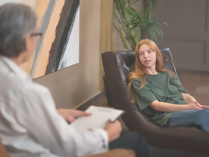 A genuine depiction of a young individual engaged in psychological therapy, revealing the authenticity of the therapeutic process
