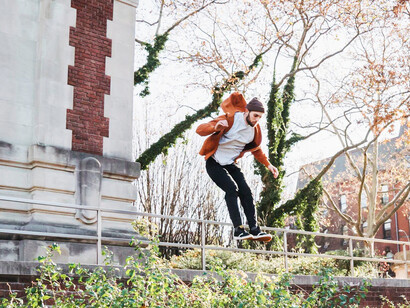 With fearless determination, a man leaps across urban obstacles, defying gravity and embracing the thrill of parkour