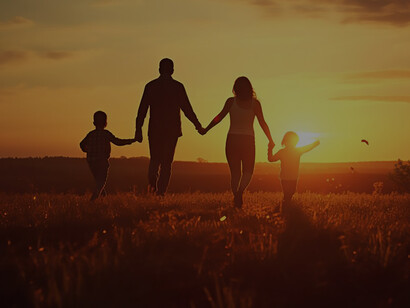 Affectionate relationship of family on a field during sunset