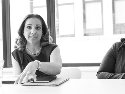 A woman speaking during a meeting, sure of herself and her place in the workforce