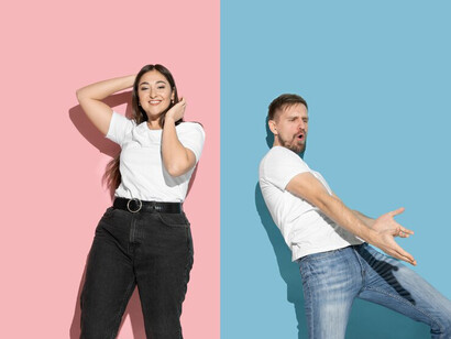 The essence of relationship dynamics, a vivid portrayal of a young emotional couple against a pink and blue wall, exuding happiness and togetherness