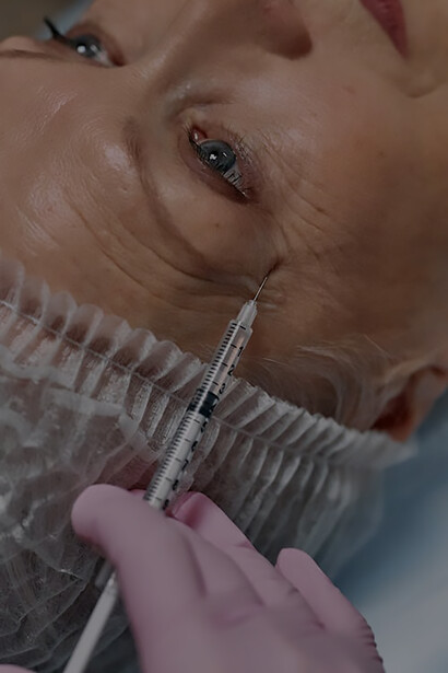 Everlasting radiance: a Senior Woman Receives Expert Filler Application from a Doctor in Pink Gloves for Timeless Facial Enhancement