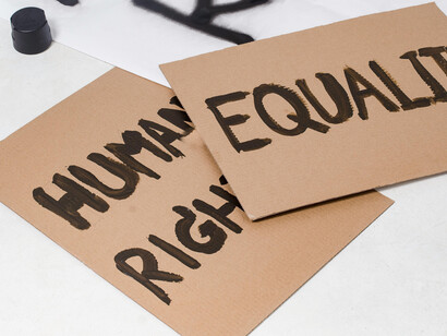 Signs made of cardboard, which read ''Equality'' and ''Human Rights''