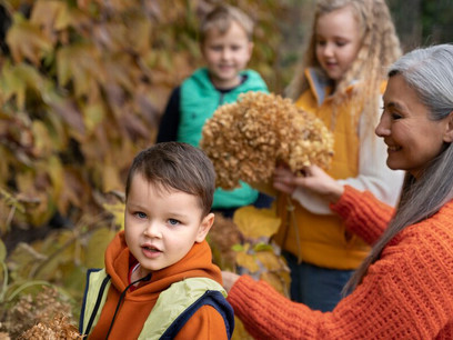 An adult guides a group of curious children as they explore the wonders of the environment, fostering a love for nature and sustainability