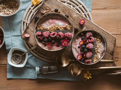 Two bowls of açaí yogurt, a nutritious fruit from Brazil presented on a wooden board