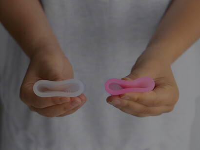 Woman organizing menstrual cups, showcasing the challenges of period poverty, menstrual product access, and the need for improved sanitation