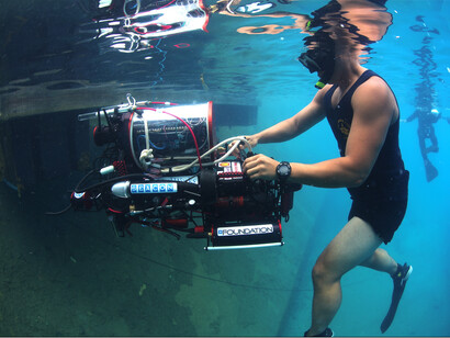 A diver recovers an automatic underwater vehicle to retrieve the data that can then be used to make better AUVs