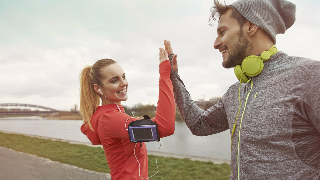 A happy couple celebrating the end of their exercise routine with a high five