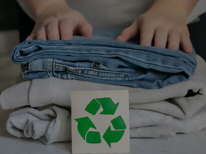 Explore garment recycling: A stack of clothes on a recycling table, ready for collection