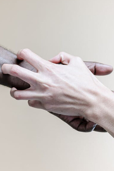 In the shared space of cultural exchange, hands reach out in acceptance, weaving a tapestry of unity where the richness of diversity flourishes under the guiding light of universal essence