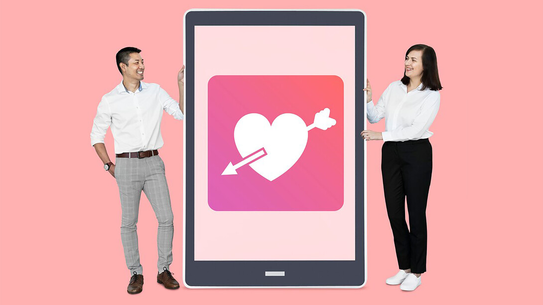 A couple viewing a dating app on a tablet, exploring online dating together