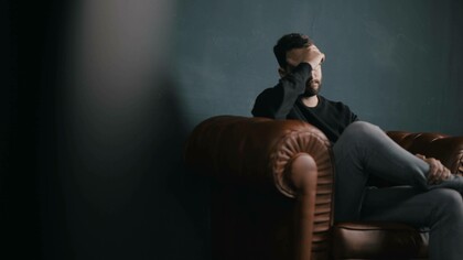 Man expressing exhaustion to therapist