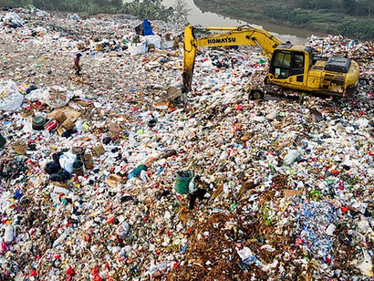 The expansive garbage dump, coupled with construction equipment occupying it, serves as a stark reminder of the urgency in prioritizing effective waste management strategies