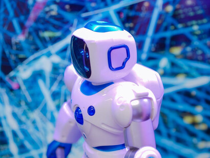 Humanoid robot walking against a blue background