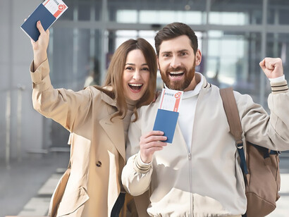 A joyful young couple holds their passports, symbolizing the global phenomenon of brain drain as skilled individuals seek opportunities abroad