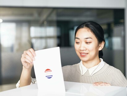 A voter submitting their ballot and being one step closer to becoming a better voter