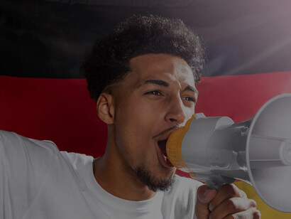 Vibrant energy of celebration featuring a cheering man amplifying his voice through a megaphone, adorned with the German flag, symbolizing national pride and exuberance