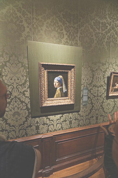 The enchanting "Girl with a Pearl Earring" by Johannes Vermeer (1632-1675) at Den Haag's Mauritshuis museum, prominently displayed in Room 15, providing a captivating glimpse into the world of Dutch Golden Age artistry