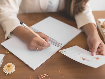 Efficiently manage wedding planning and budget control with a top view of a woman working diligently to orchestrate the perfect celebration