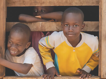 African migrant children pose by the window in South Africa