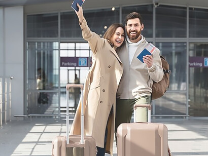 With passports in hand, a delighted young couple represents the brain drain trend, where talented individuals migrate overseas in pursuit of better prospects