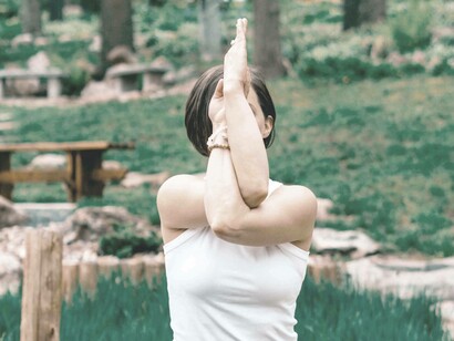 A woman in a unique mediation pose is attempting to access her third eye