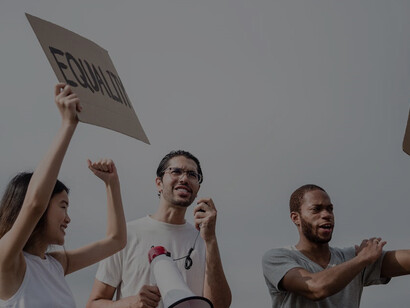 Protesters holding placards at a demonstration