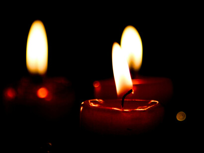 Set a of three candels glisten with a redish yellow hue in the dark