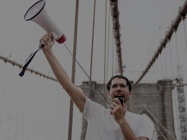 Angry protester holding a megaphone at a demonstration
