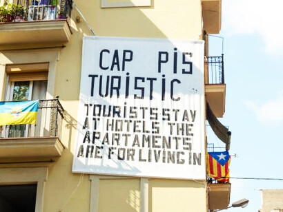 Residents in the Barceloneta neighborhood of Barcelona express their concerns about holiday apartments crowding balconies and the overwhelming influx of tourism, highlighting the city's housing crisis and soaring rental prices