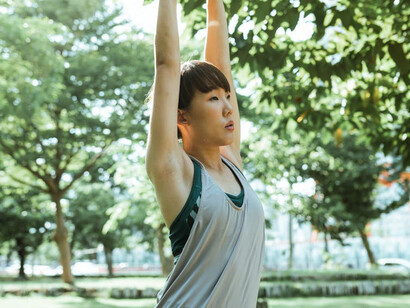 Stretching before her jog, she's setting the stage for a workout that will not only energize her body but also boost her mood and mental resilience