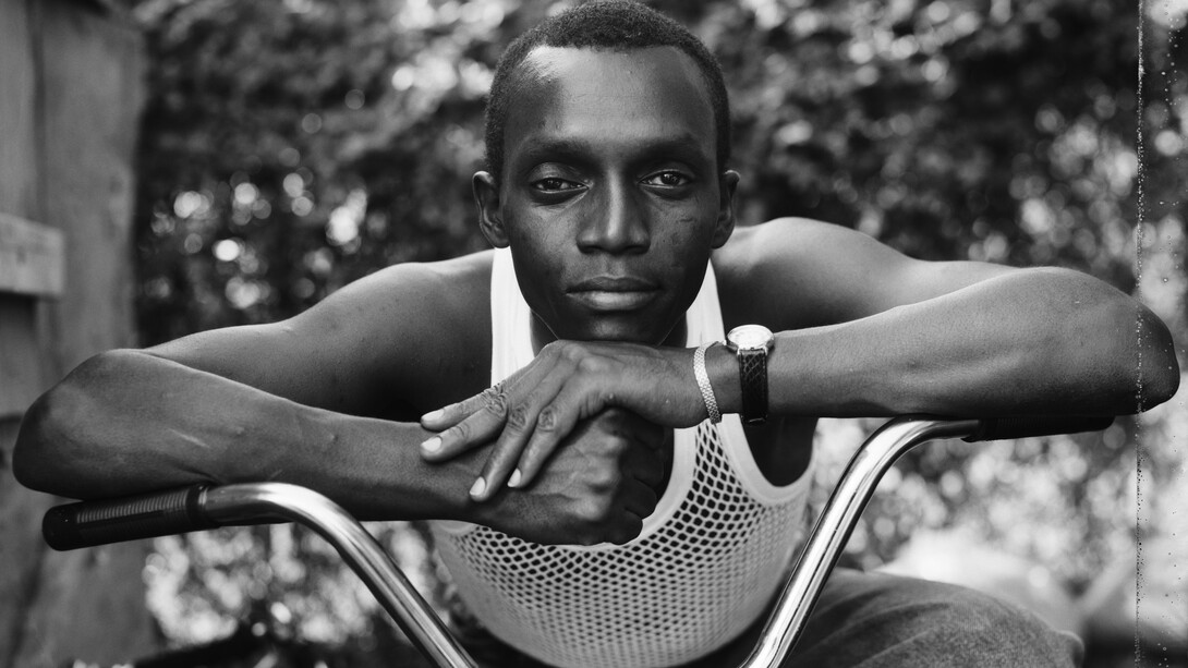 Dawoud Bey, A young man resting on an exercise bike, Amityville, NY, 1988. Courtesy of Denver Art Museum
