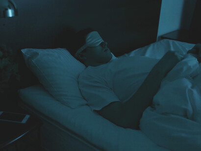 Settling into bed, he embraces the transformative power of sleep, essential for mental clarity and emotional balance