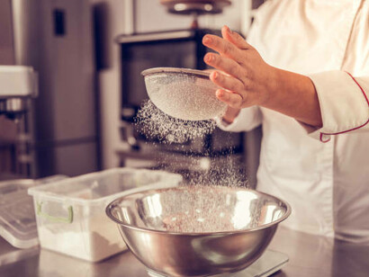 Flour passes through a sieve, symbolizing the effectiveness of a filtration system