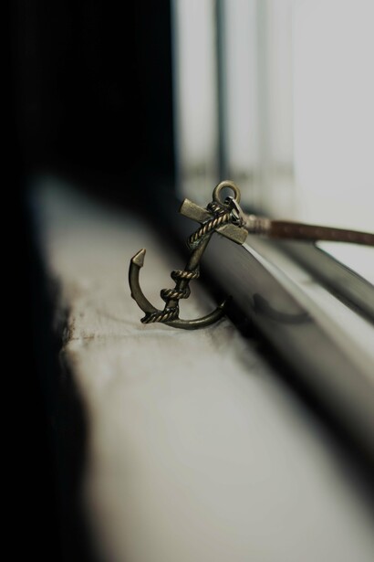 Anchor styled keychain abandoned on shabby windowsill