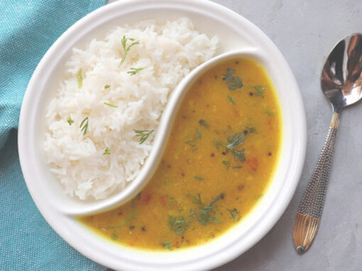 Dal bhat is a staple Nepalese dish featuring steamed rice served with flavorful lentil soup, accompanied by a variety of side dishes like vegetable curries and pickles