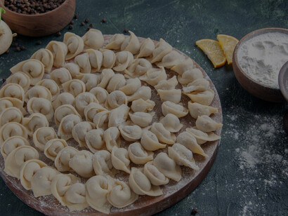 Beautifully arranged and perfectly stuffed dumplings /mantı rest on the tray