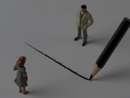 A line drawn from above separates two people from each other