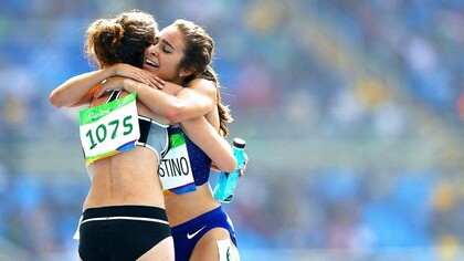 Kiwi Nikki Hamblin (left) and American Abbey D'Agostino thank each after a fall in the women's 5000m heats