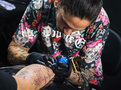 A tattoo artist working on his soul-aligned business plan by becoming a store owner