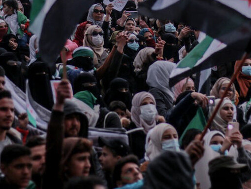 In the heart of Syria, passionate voices rise as protesters gather, united in their demand for peace amid the chaos of conflict