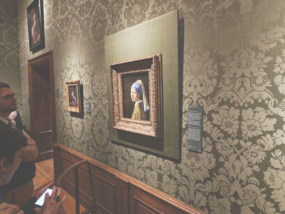 The timeless allure of "Girl with a Pearl Earring" by Johannes Vermeer (1632-1675), exhibited in Room 15 of the renowned Mauritshuis museum located in Den Haag, Netherlands, showcasing the beauty of Dutch Golden Age artistry