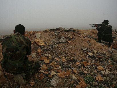 Armed men on the frontlines, part of the battle against forces opposing Bashar al-Assad, Syria