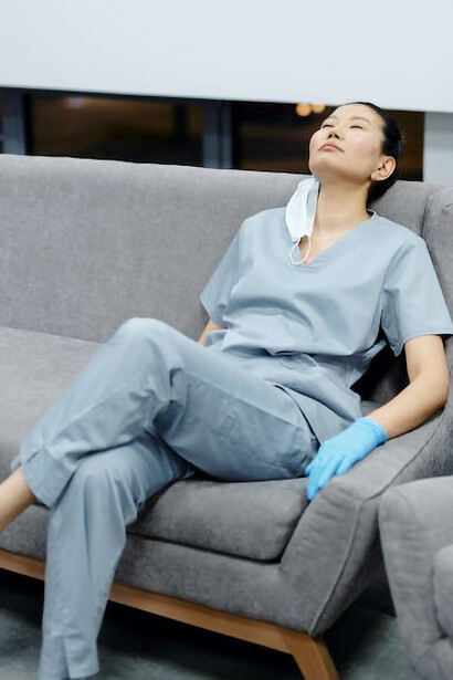 A fatigued nurse seeking solace in a comfortable chair