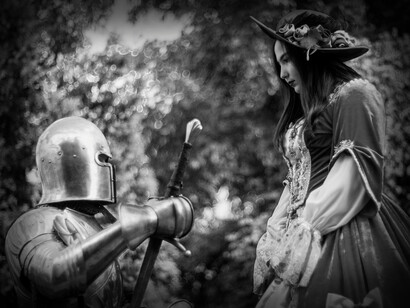 A knight puts his sword away in the presence of a lady